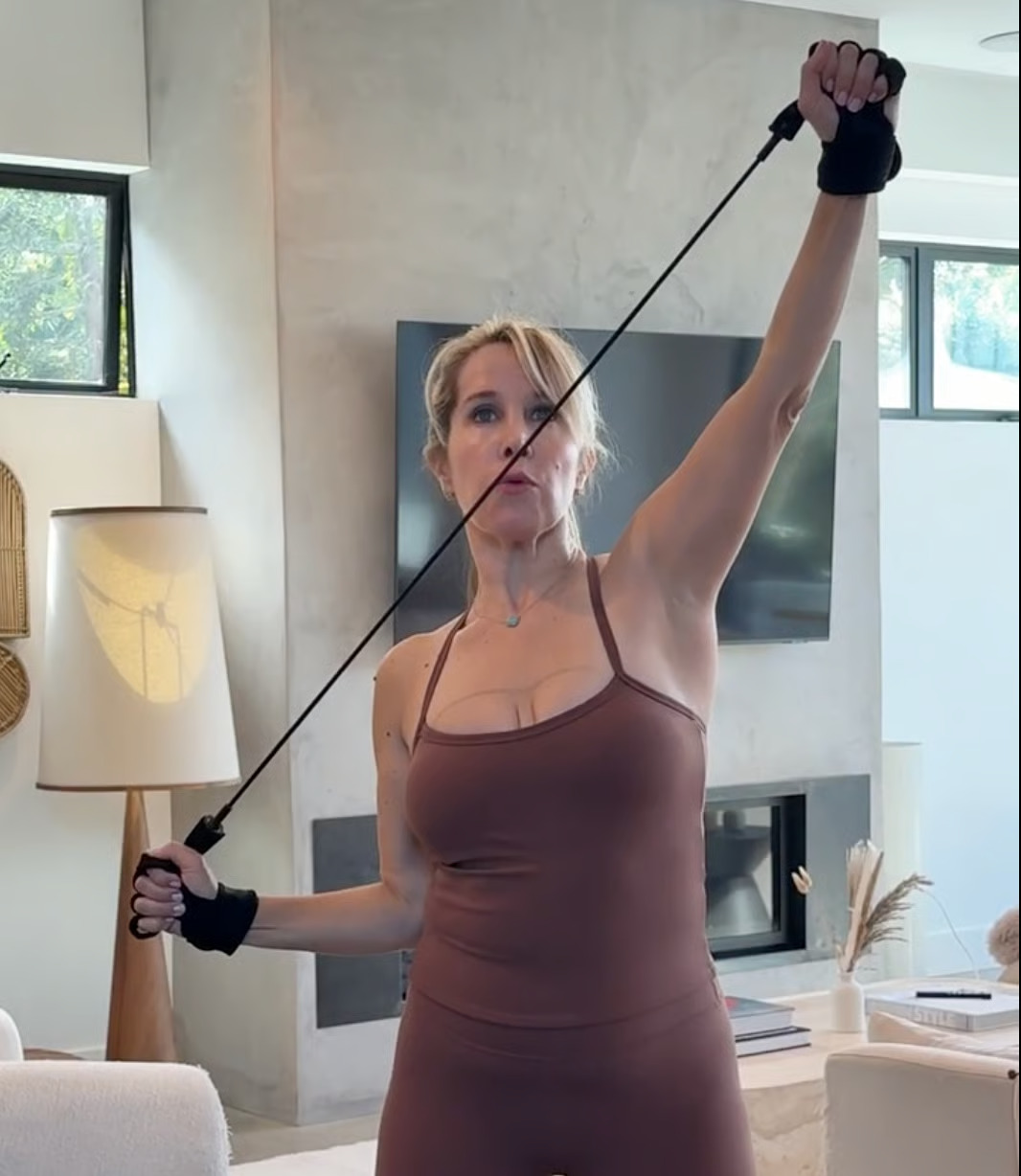 Woman exercising with resistance bands in a living room
