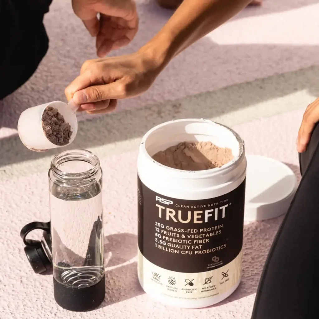 Hand pouring truefit powder into water bottle