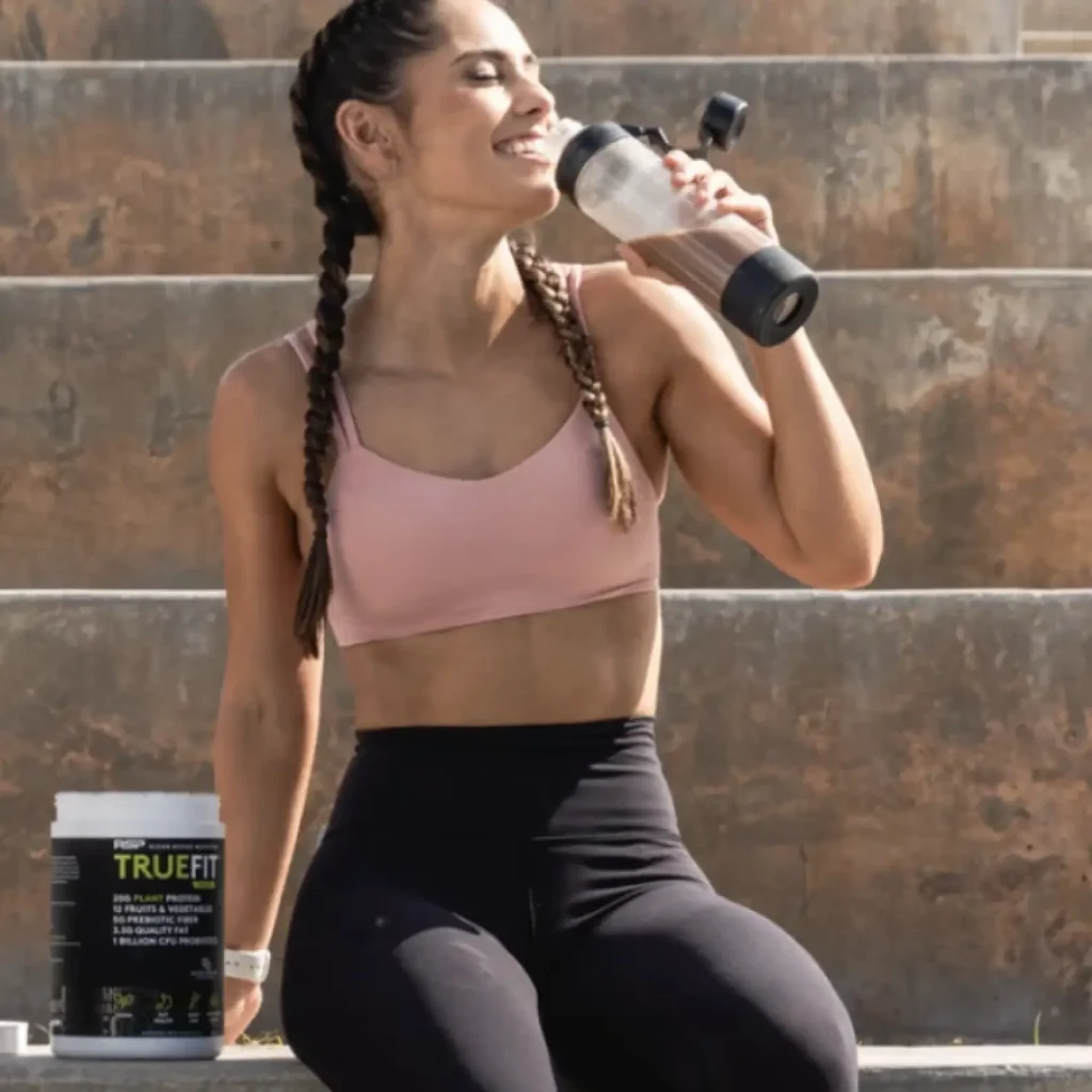 woman smiling and drinking truefit